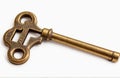 A single old brass key, cut out on white background Royalty Free Stock Photo