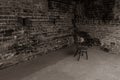 Single, old chair against old brick wall - black and white photo Royalty Free Stock Photo