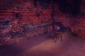 Single, old chair against old brick wall - vivid photo with vigentte Royalty Free Stock Photo