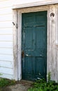 Single Old Door with Peeling Paint and Horseshoes
