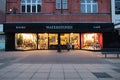 A single older person reads a sign outside a closed branch of the UK bookseller Waterstones