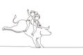 Single one line drawing happy cute kid boy and girl riding cute bull together. Children sitting on back bull with saddle in cowboy