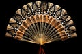 single open hand fan with intricate patterns, isolated on black