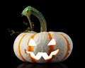 Single orange striped pumpkin jack-o-lantern on black