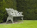 Single Ornate Iron made seat or Bench in garden