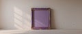 A single ornate purple picture frame sits on a wall Royalty Free Stock Photo