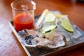 Single oyster with cocktail sauce