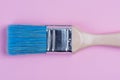 Paintbrush tool top view on pastel background