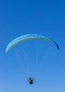 Paragliding in mid air with blue sky