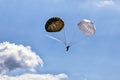 Single paratrooper with pair of vintage parachutes Royalty Free Stock Photo