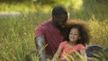 Single parent father taking care of treasured little daughter with curly hair