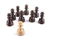 Single pawn against all black pawns isolated on white background - concept of an unequal struggle