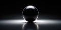 A single, perfectly smooth, black sphere rests on a reflective surface, illuminated by a subtle light source. Generative AI Royalty Free Stock Photo