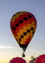 Single person hot air balloon taking off at sunrise