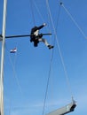 Single person up in the rigging of a sailboat