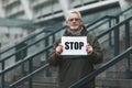 Single picket of the senior man. The activist holds a \