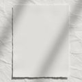 A close-up of a blank, lined notepad on a smooth, light gray surface. The notepad is oriented at a Royalty Free Stock Photo