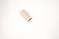 a single piece of brown toilet paper roll on a plain white background. how everyday objects can be transformed into part Royalty Free Stock Photo