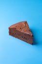 One slice of Kladdkaka on a blue background. Chocolate cake piece Royalty Free Stock Photo