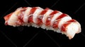 A single piece of sushi with sliced squid on top of rice Royalty Free Stock Photo