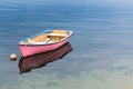 A single pink boat in clear blue water Royalty Free Stock Photo