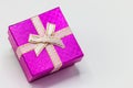 Single pink gift box with silver ribbon on white background. Royalty Free Stock Photo