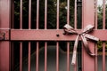 Single pink ribbon tied on a wrought iron gate Royalty Free Stock Photo
