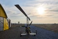 Single place ultralight homemade gyroplane stands at the airport near the hangar in the early morning.