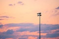 Single pole or column of spotlight or stadium light in arena with sunset beautiful sky and with copy space Royalty Free Stock Photo