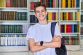 Single portrait of smiling confident male student teenager looking at camera in library Royalty Free Stock Photo