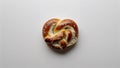 Single pretzel bite with browned top and fluffy interior placed flat on white background Royalty Free Stock Photo