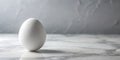 A single, pristine white egg rests on a polished marble surface against a subtly textured backdrop. Generative AI Royalty Free Stock Photo