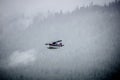 Single Prop Airplane Pontoon Plane flying through fog over Alaska Last Frontier Royalty Free Stock Photo