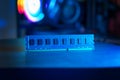 Single RAM memory module on desk with blue lighting, modern gaming computer background, concept of hardware upgrade, performance Royalty Free Stock Photo