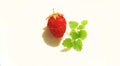 single ripe strawberry on a plate with mint leaves Royalty Free Stock Photo