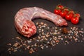 single raw turkey neck served with spices and tomatoes Royalty Free Stock Photo