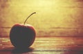 single red apple alone on wooden background dark tone Royalty Free Stock Photo