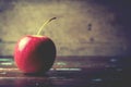 Single red apple alone on wooden background dark tone Royalty Free Stock Photo