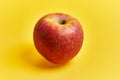 Single red apple fruit over yellow background Royalty Free Stock Photo