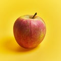 Single red apple fruit over yellow background Royalty Free Stock Photo
