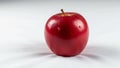 Rests against a white background. The apple is glossy with tiny water Royalty Free Stock Photo