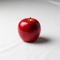 A single red apple with a shiny surface sits on a plain white background Royalty Free Stock Photo