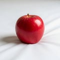 Lighting creates a gentle shadow beneath the apple, highlighting Royalty Free Stock Photo