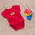 Single red baby bodysuit with plastic toy keys