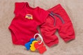 Single red baby bodysuit with plastic toy keys