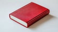 A single red book on a white surface Royalty Free Stock Photo