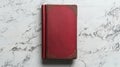 A single red book on a white surface Royalty Free Stock Photo