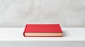 A single red book on a white surface Royalty Free Stock Photo