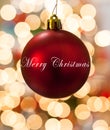 Single Red Christmas Ornament hanging in front of lights Royalty Free Stock Photo