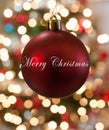 Single Red Christmas Ornament hanging in front of lights Royalty Free Stock Photo